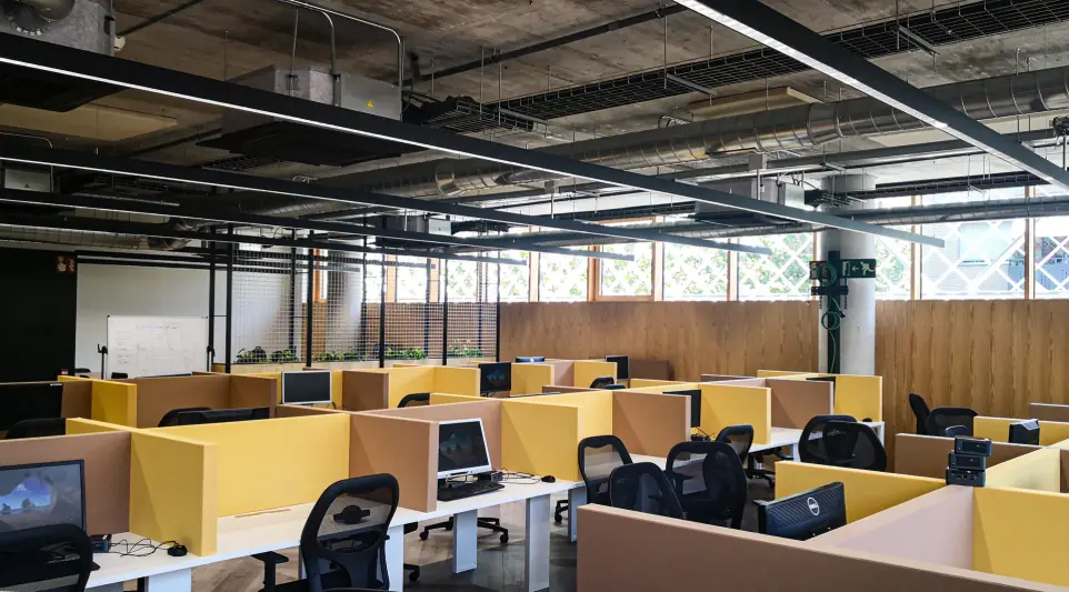 Proyecto de iluminación Luxes en oficinas KNEM: espacios amplios y confort visual para el trabajo. Iluminación LED en área de trabajo abierta de las oficinas KNEM, diseño lumínico de Luxes.